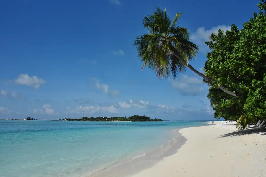 Golden-hour view across a Maldives overwater villa lagoon