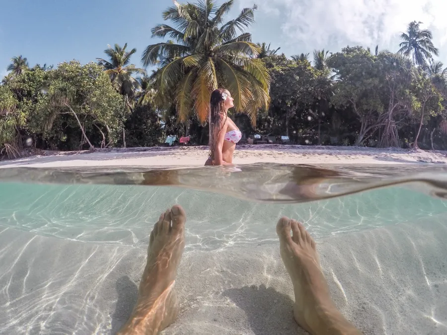 Snorkeling in clear Maldives water over shallow reef