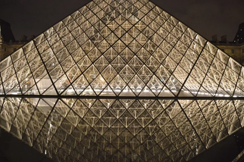 Inside the Louvre in the evening with grand galleries and warm light